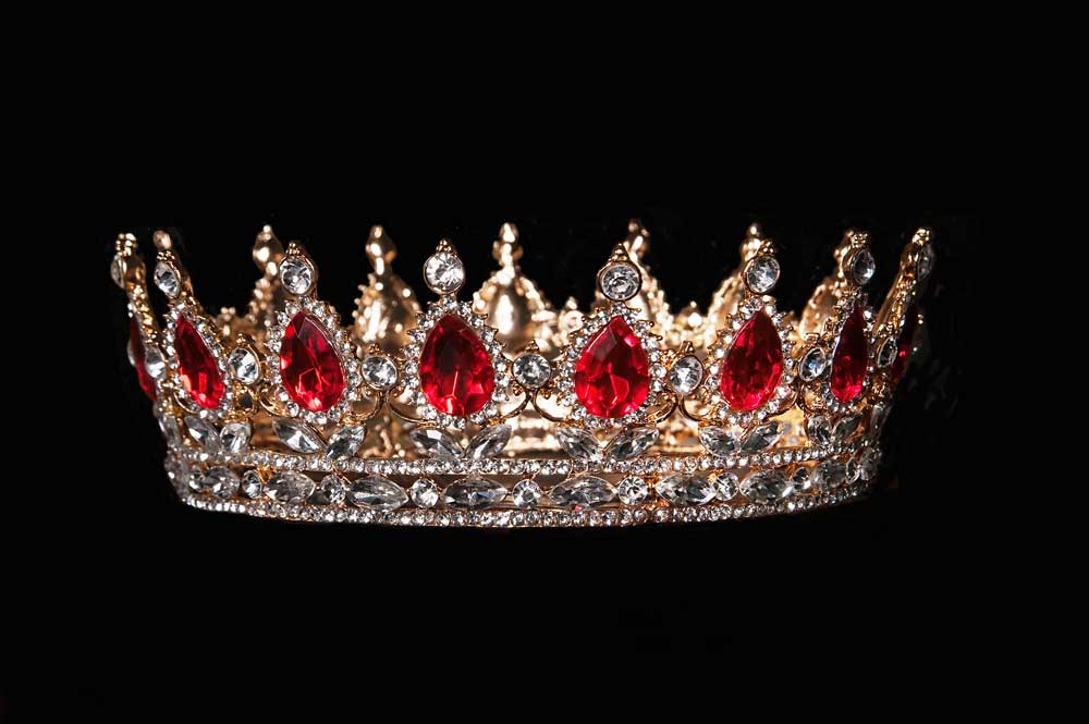 Couronne royale sertie de rubis rouge vif, représentant le luxe et l'héritage historique des pierres précieuses.